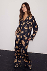 Black Deloris Button Through Pyjamas with iconic gold motifs, worn by a 5ft7” model in a UK size 10.