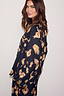 Thumbnail for Deloris Button Through Pyjamas in black featuring gold hand and heart motifs, worn by a model looking over her shoulder.