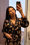 Deloris Button Through Pyjamas in black with iconic NFD motifs and gold piping, shown in a mirror selfie.