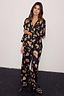 Deloris Button Through Pyjamas in black with gold hand, heart and eye motifs, featuring a button-up shirt and trousers.