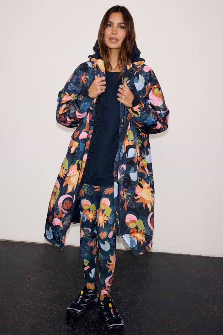 Navy Charm Coat with a colourful celestial print, featuring a cosy borg lining and waterproof fabric.