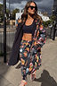 Thumbnail for Navy Charm Coat featuring a hand-painted charm print and black borg lining, styled for a London look outdoors.