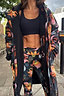 Navy waterproof Charm Coat featuring a multi-colour charm print and black borg lining, styled with matching activewear.