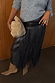 Black Leather Fringe Belt with a wide buckled band and long tassels layered over a tonal skirt and grey knit.