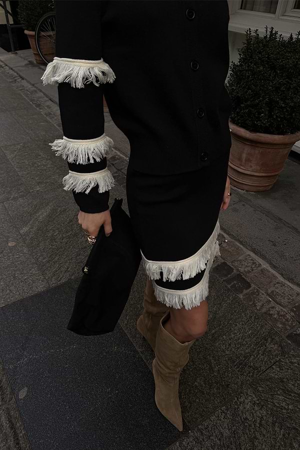 Black and Cream Fringe Jake Skirt with tiered knit fringe, styled with a matching cardigan and slouchy boots.