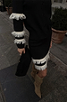 Black and Cream Fringe Jake Skirt with tiered knit fringe, styled with a matching cardigan and slouchy boots.