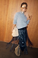 Black Leather Fringe Belt with long tassels, styled with a grey jumper and tan boots to show movement.