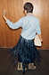 Black Leather Fringe Belt with long moving tassels layered over a black midi skirt and grey jumper.