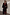 Thumbnail for Black Leather Fringe Belt with long fringe and wide waistband, styled over a cherry print maxi dress and blazer.