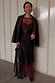 Black Leather Fringe Belt with long fringe and wide waistband, styled over a cherry print maxi dress and blazer.