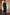 Thumbnail for Black Leather Fringe Belt with a wide band and long fringe, styled over a forest green maxi dress.