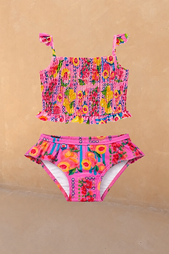 Girls pink fruit print bikini featuring a shirred bandeau top with ruffle straps and matching frilled bottoms.