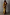 Thumbnail for Gold Fringe Dress with tiered gold foil tassels and a midaxi silhouette, worn by a model against a grey wall.