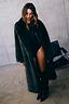 Green Faux Fur Coat in a relaxed silhouette, styled with a black studded bodysuit and tall black boots.