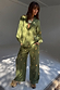 Khaki Shell Trousers featuring a gold shell print and wide-leg fit, styled as a co-ord set with a matching shirt.