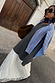 Grey Knit Jumper Dress with a sheer cream lace skirt, layered with a blue striped shirt and brown suede bag.
