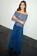 Charcoal Diaz Top in ruched grey mesh with an off-the-shoulder neckline, paired with wide-leg blue denim jeans.