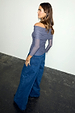 Charcoal Diaz Top in grey mesh with ruched off-the-shoulder detail and sheer sleeves, paired with wide-leg blue jeans.