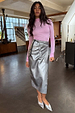 Gunmetal Vegan Leather Jaspre wrap skirt styled with a lilac top and metallic silver heels.