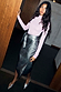 Gunmetal Vegan Leather Jaspre Skirt paired with a pink turtleneck and silver pointed heels.