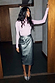 Gunmetal Vegan Leather Jaspre Skirt styled with a pink long-sleeved top and silver heels.