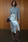 Grey Gunmetal Rib Knit Jumper with a roll neck and shimmering silver flecks, tucked into a silver metallic skirt.