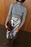 Thumbnail for Gunmetal Rib Knit Jumper with a roll neck and silver flecks, styled with a silver metallic wrap skirt.