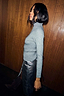 Gunmetal Rib Knit Jumper with a roll neck and silver shimmer, styled with a metallic silver skirt.