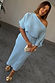 Ice Blue Plisse Tilly Dress featuring a silver metallic brushstroke print, asymmetric neckline and elasticated waist.