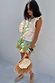 Multi-coloured Isla Ruffle Shorts with tiered lace detailing and a hand-painted print, styled for a vacation look.