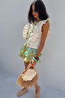 Multi-coloured Isla Ruffle Shorts with tiered lace detailing and a hand-painted print, styled for a vacation look.