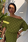 Thumbnail for Khaki Plisse Tilly Dress featuring gold metallic flecks and an off-the-shoulder neckline in the sun.