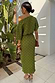 Khaki Plisse Tilly Dress with gold metallic flecks, styled with a one-shoulder neckline in a sunlit vacation setting.