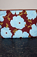 Blue & Burgundy Poppy Laptop Case featuring light blue poppies on a burgundy background with a gold zip.