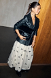 Black Leather Blazer in a relaxed fit, styled with a white bow-detail tulle skirt and a textured bag for a London look.
