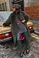 Bottle Green Studded Vegan Leather Trousers with side stud detailing, styled with a faux fur coat by a vintage car.