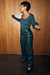 Thumbnail for Bottle green studded vegan leather trousers with metallic side detailing, styled with a matching green top.