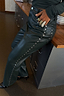 Thumbnail for Bottle Green Studded Vegan Leather Trousers featuring silver metallic side studs and a high-waisted fit.