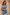 Thumbnail for Blue and Lemon Kira Top with contrast lemon lace trim and an asymmetric hem, worn by a model.