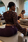Dark Leopard Ballet Wrap top with orange accents, flared sleeves and back neck logo, styled in a pilates studio.