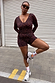 Dark Leopard Ballet Wrap with orange accents and flared sleeves, styled with matching shorts and white trainers.