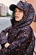 Dark Leopard Cap in iconic burgundy leopard print, styled with a matching hooded jacket for a casual London look.
