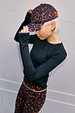 Dark Leopard Cap with a burgundy twist, styled with matching leopard leggings and a black long-sleeved top.