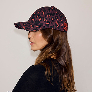 Cotton Dark Leopard Cap in iconic leopard print with burgundy tones, shown in profile on a model.