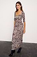 Thumbnail for Leopard Iris Dress with ruched waist detail and elbow sleeves, styled with black pointed-toe boots.