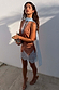 Fawn print Mini Maeva Skirt in brown with light blue lace trim, styled with a matching top in a sunny outdoor setting.