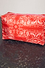 Red Bandana Reversible Make Up Bag featuring a white paisley print, pink top zip, and branded logo patch.