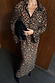 Cherry Leopard Mia Dress featuring a leopard print with red cherry details, button up front and long sleeves.