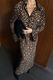 Cherry Leopard Mia Dress featuring a leopard print with red cherry details, button up front and long sleeves.