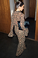 Cherry Leopard Mia Dress with leopard and cherry print, flared sleeves and maxi length, styled with a black clutch.